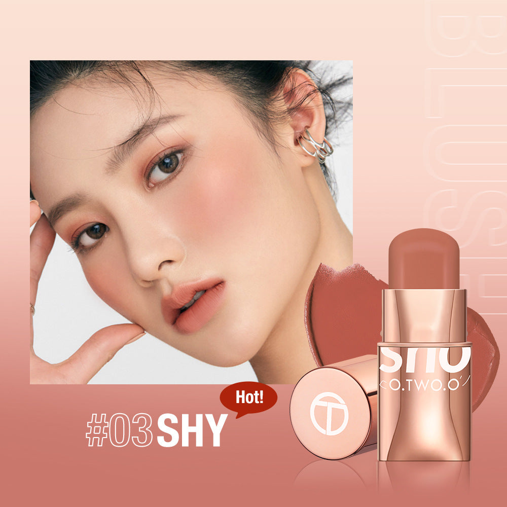 Blush stick applied to cheeks